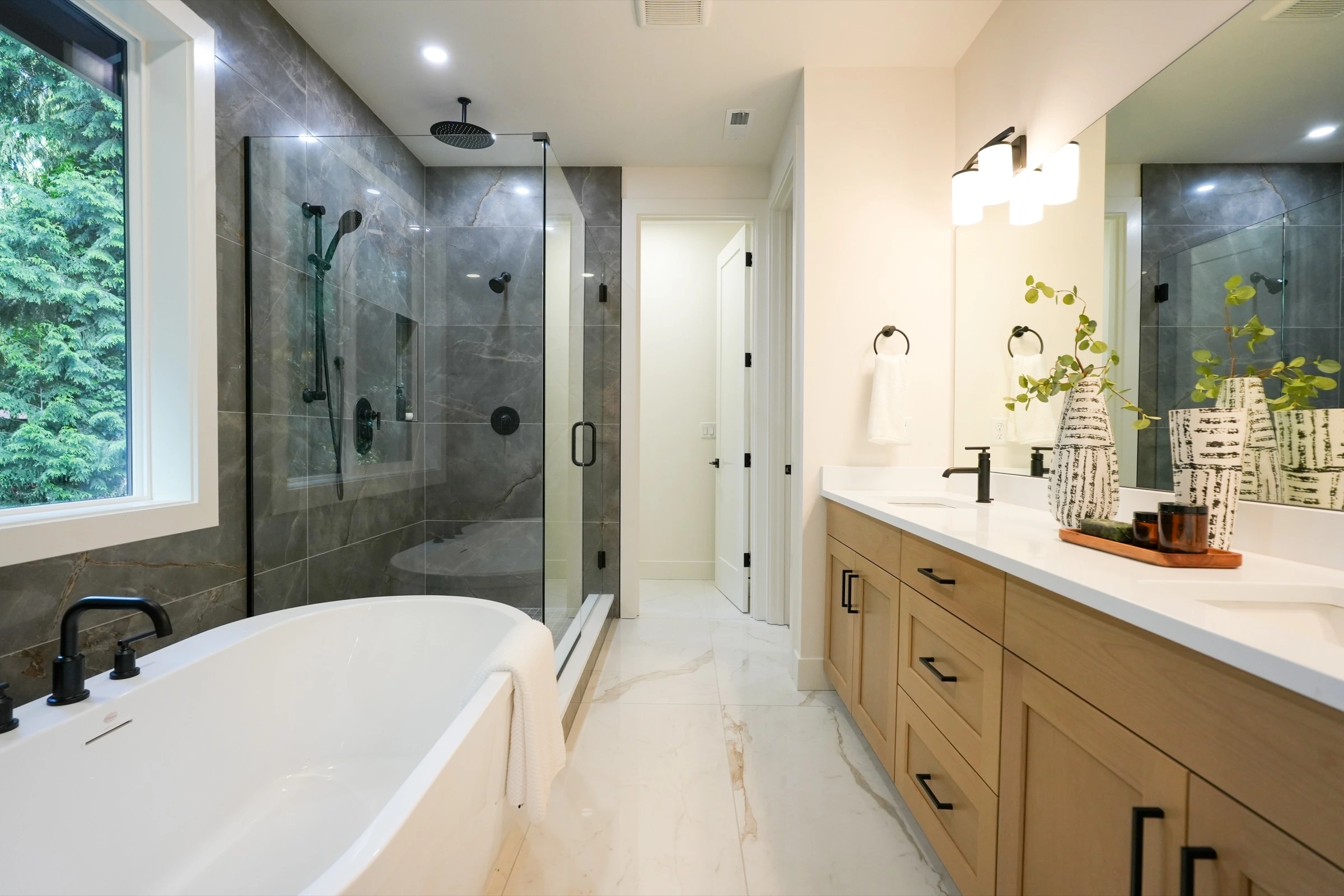 Modern bathroom with freestanding tub, walk-in shower, and wood vanity